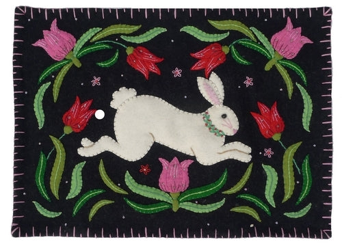Embroidered patch with a white rabbit and flowers on a black background