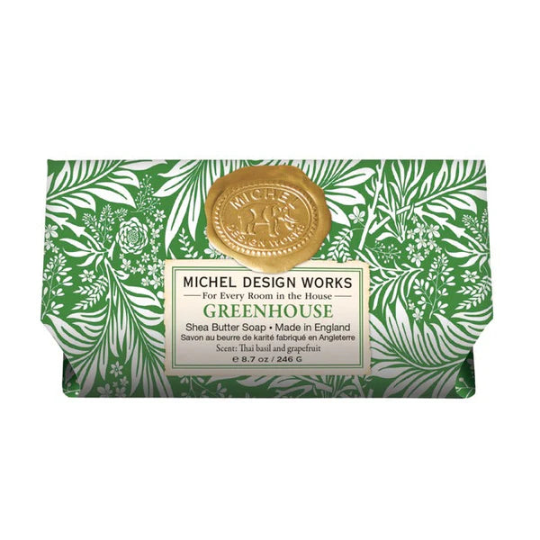 Bar of soap with green leafy design packaging and gold seal, featuring Michel Design Works branding.