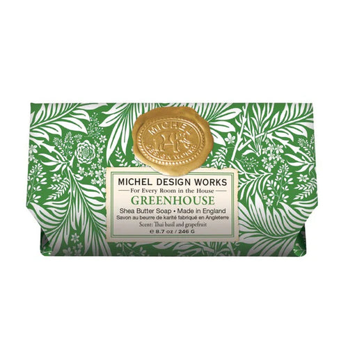 Bar of soap with green leafy design packaging and gold seal, featuring Michel Design Works branding.
