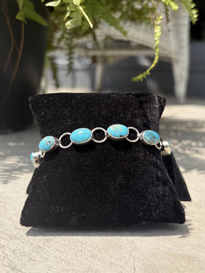 A sterling bracelet with oval turquoise stones 